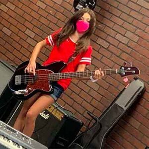 Girl playing guitar at summer camp